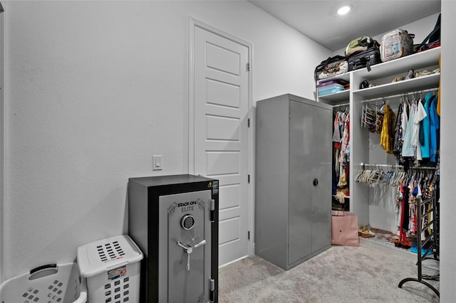 walk in closet featuring light carpet