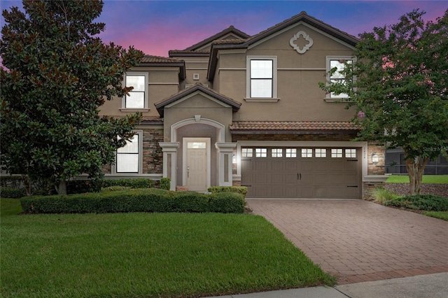 view of front facade with a lawn and a garage