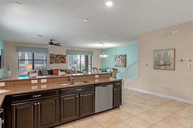 kitchen featuring dishwasher, sink, hanging light fixtures, light stone countertops, and ceiling fan with notable chandelier