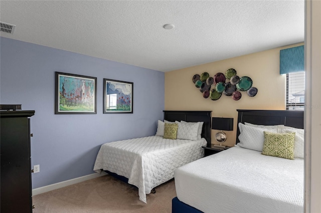 bedroom with a textured ceiling and carpet