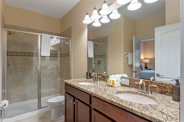 bathroom featuring tile patterned floors, a shower with door, toilet, and vanity