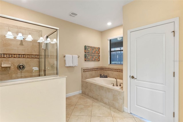 bathroom with tile patterned floors and shower with separate bathtub