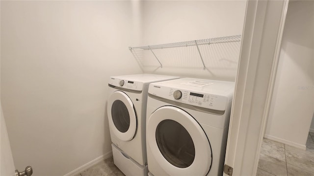 laundry room featuring separate washer and dryer and light tile patterned floors