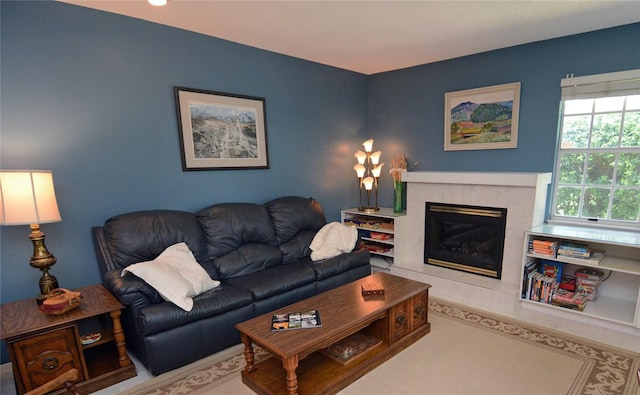 living room with a tile fireplace