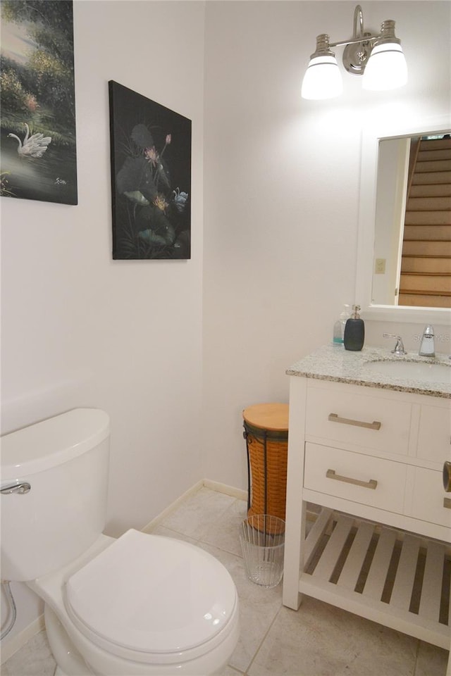 bathroom featuring vanity, toilet, and tile patterned flooring