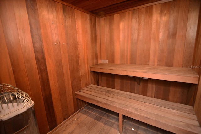 view of sauna / steam room featuring wood walls and wood-type flooring