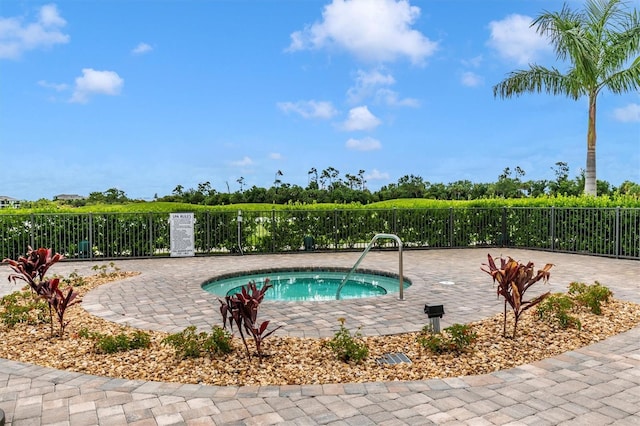 view of pool with a hot tub