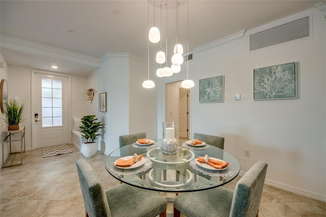 dining area featuring crown molding