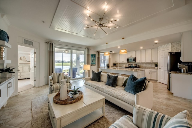 living room featuring light tile patterned floors and an inviting chandelier