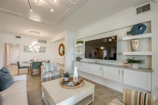 living room with light tile patterned floors and crown molding