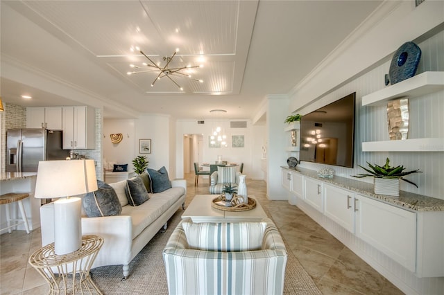 living room featuring ornamental molding and an inviting chandelier