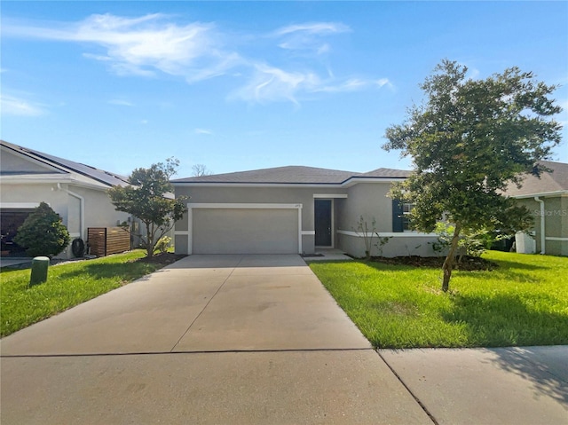 view of front of property featuring a front yard and a garage