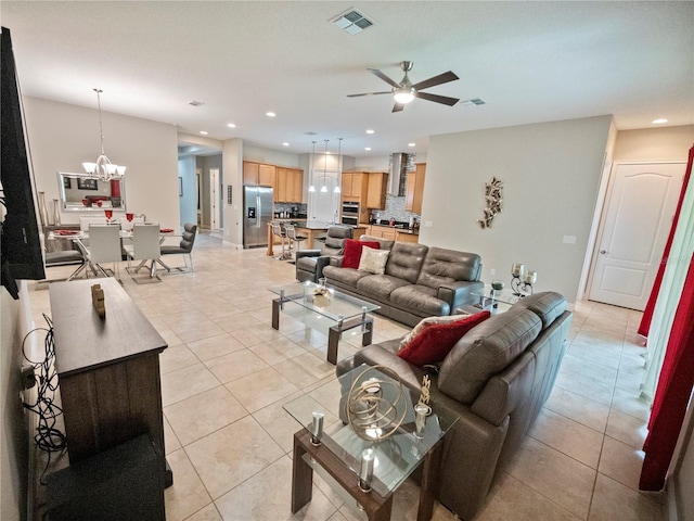 tiled living room featuring ceiling fan with notable chandelier