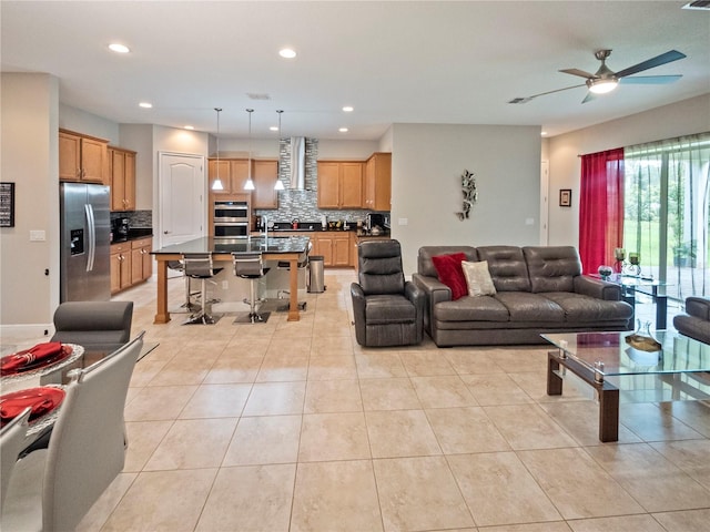 living room with ceiling fan and light tile patterned floors