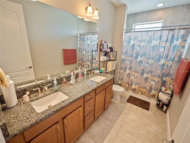 full bathroom with vanity, shower / tub combo, tile patterned floors, and toilet