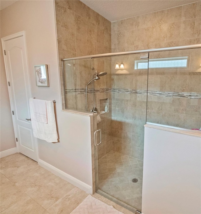 bathroom with walk in shower and tile patterned flooring