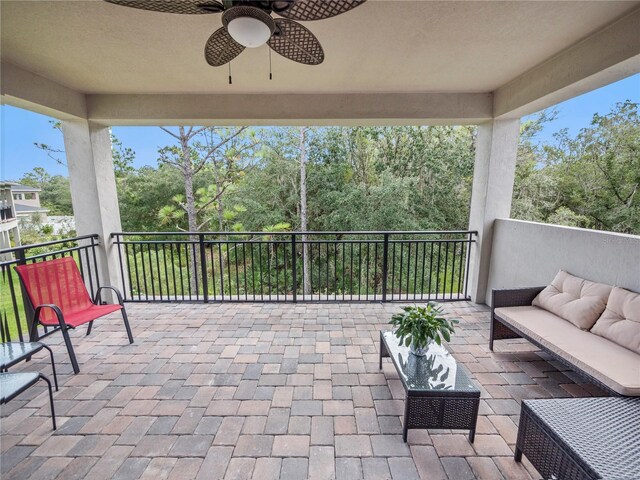 view of patio / terrace with an outdoor living space, a balcony, and ceiling fan