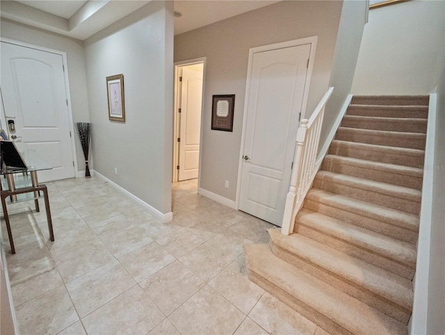 foyer entrance with light tile patterned floors