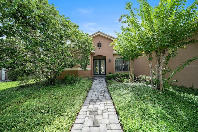 view of front of home featuring french doors and a front yard