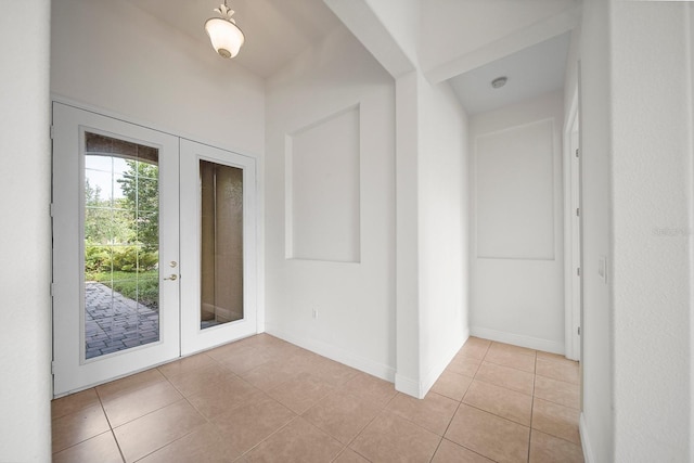 tiled entrance foyer featuring french doors