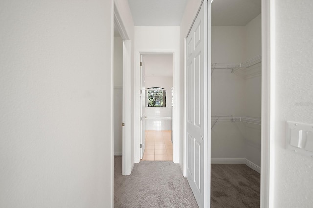 hall with light colored carpet