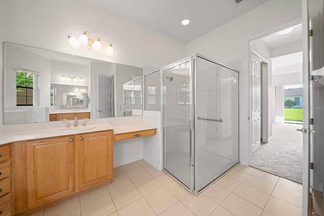 bathroom with tile patterned flooring, a shower with shower door, and vanity