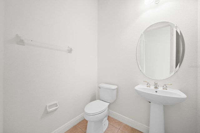 bathroom with sink, tile patterned flooring, and toilet