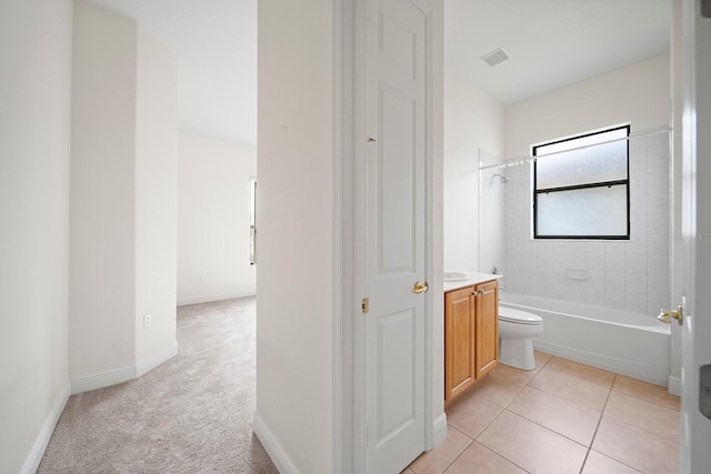 full bathroom with toilet, vanity, tile patterned flooring, and tiled shower / bath combo