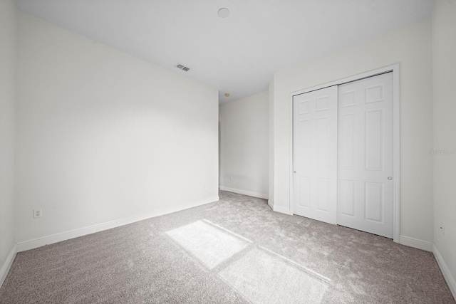 unfurnished bedroom featuring a closet and carpet flooring