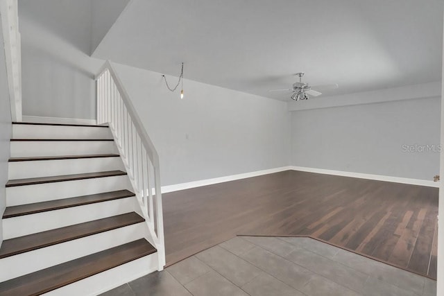 stairs featuring ceiling fan and tile patterned flooring