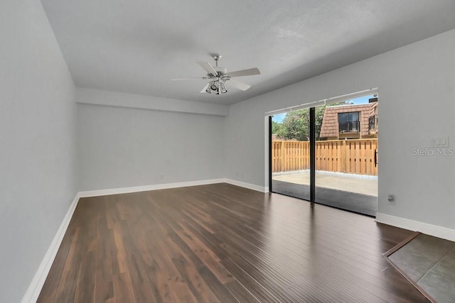 spare room featuring ceiling fan and dark hardwood / wood-style flooring