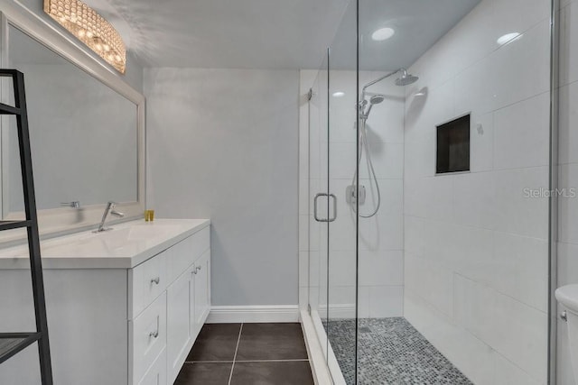 bathroom with vanity, tile patterned flooring, a shower with door, and toilet