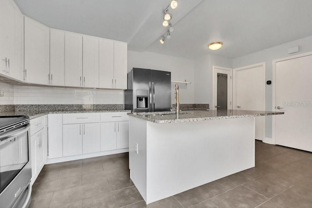 kitchen with stainless steel appliances, light stone countertops, a kitchen island with sink, and white cabinets