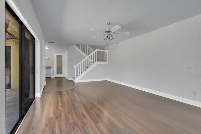 unfurnished living room with ceiling fan and dark hardwood / wood-style flooring