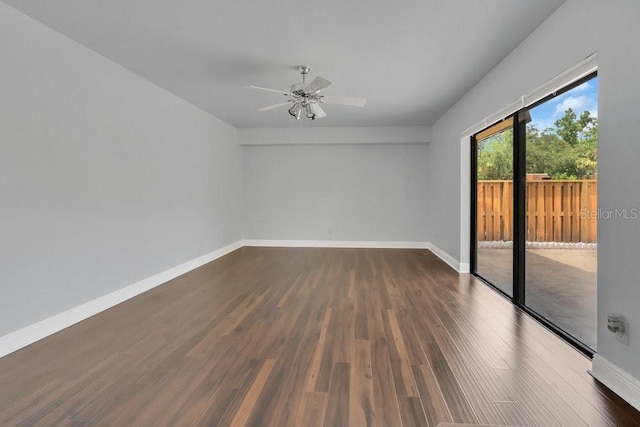 empty room with ceiling fan and dark hardwood / wood-style flooring