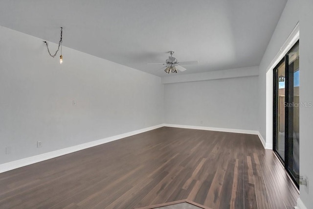 spare room with ceiling fan and dark hardwood / wood-style flooring