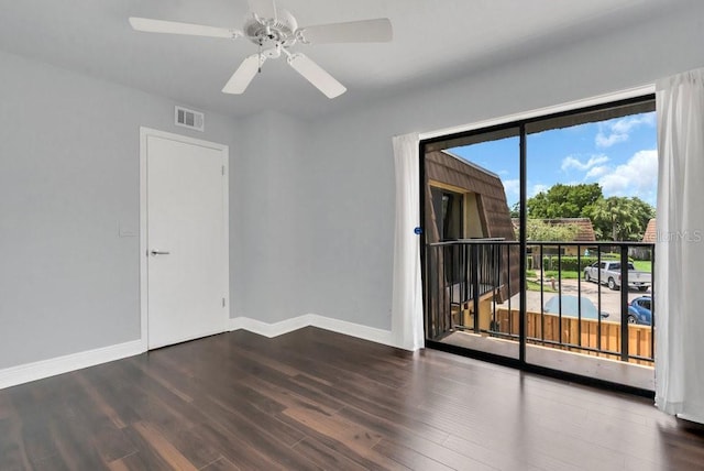 empty room featuring ceiling fan and dark hardwood / wood-style flooring