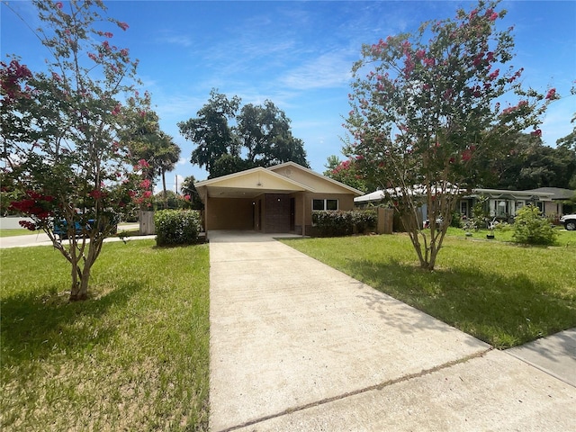 view of front of house with a front yard and a carport