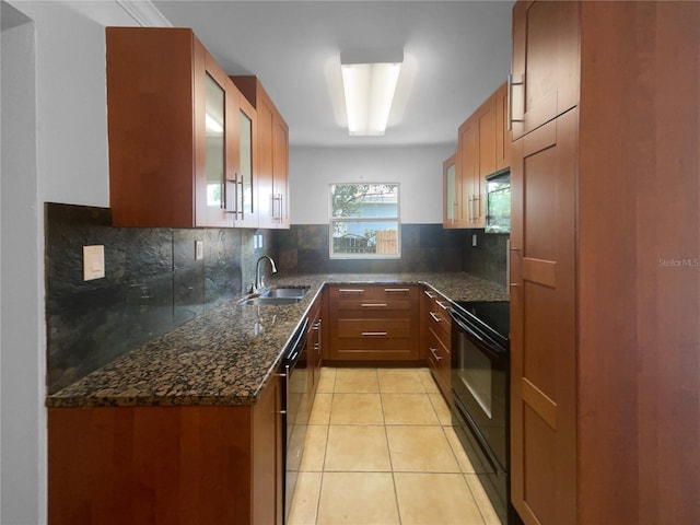 kitchen featuring dark stone counters, tasteful backsplash, black range with electric cooktop, sink, and light tile patterned floors