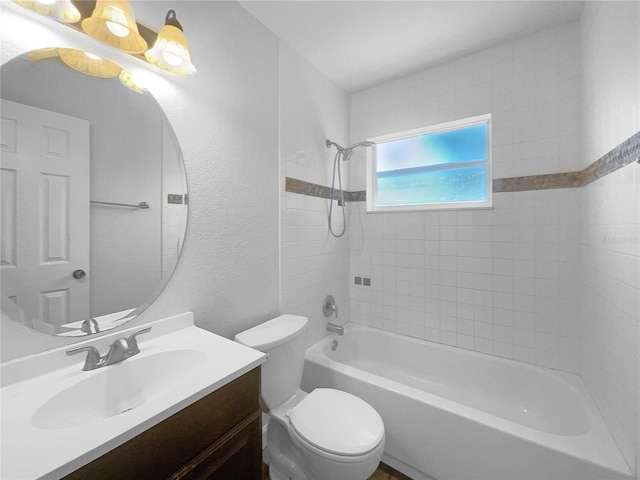 full bathroom featuring tiled shower / bath combo, toilet, and vanity