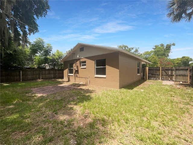 rear view of property featuring a yard