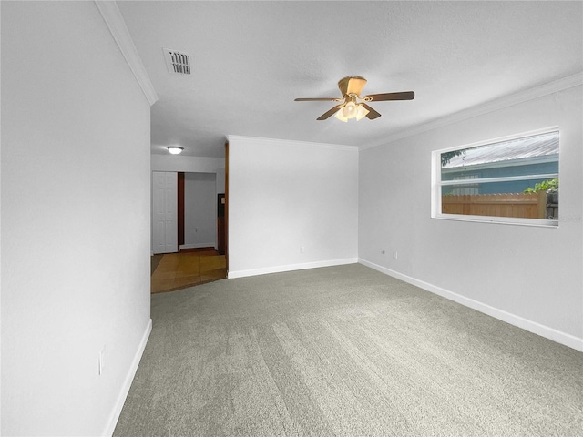 carpeted empty room featuring crown molding and ceiling fan