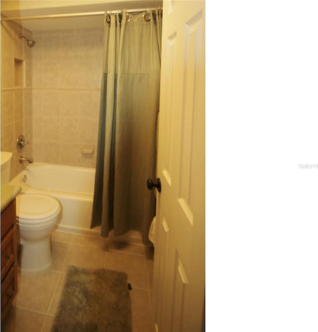 full bathroom featuring vanity, tile patterned flooring, toilet, and shower / bathtub combination with curtain