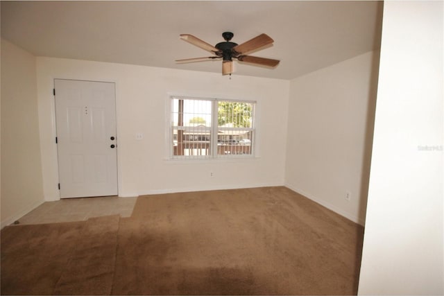 unfurnished room featuring light colored carpet and ceiling fan