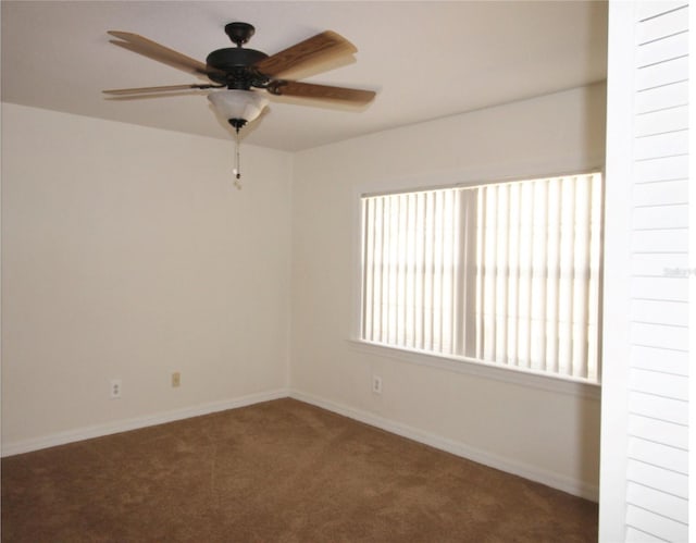 carpeted empty room featuring ceiling fan