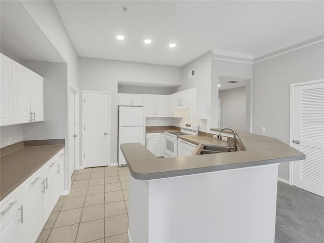 kitchen featuring white appliances, white cabinets, a center island with sink, sink, and light tile patterned flooring