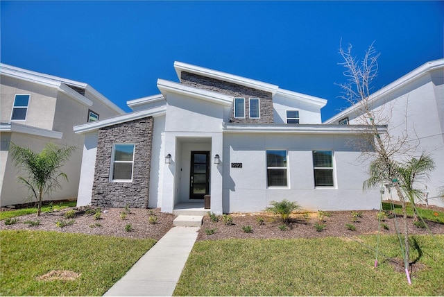 contemporary house featuring a front yard