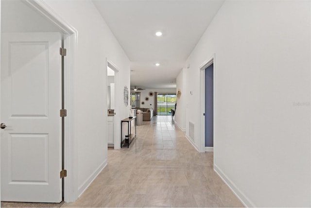 corridor with light tile patterned floors