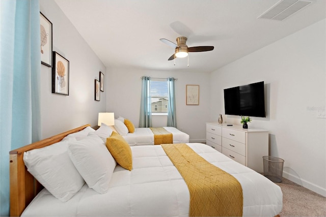 bedroom featuring light carpet and ceiling fan