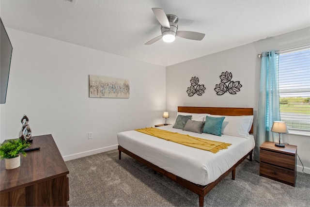 carpeted bedroom with multiple windows and ceiling fan